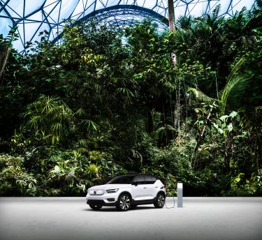 Volvo electric car charging with Eden Rainforest in the background